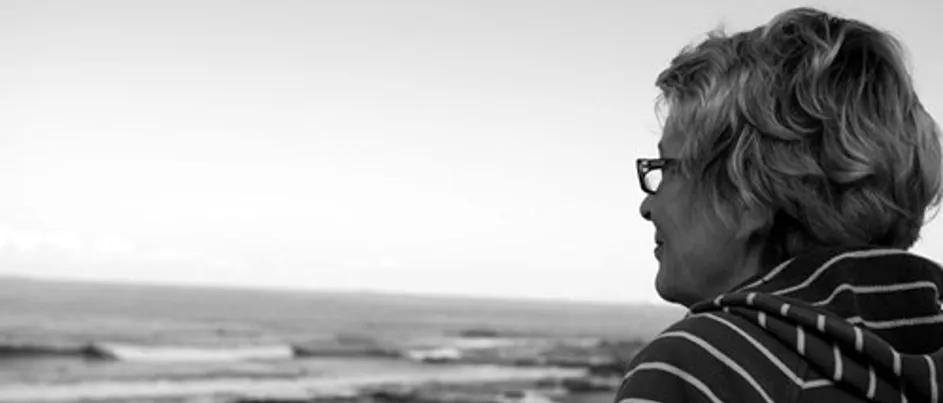 Anna, Kate's mum, looking at the beach smiling.