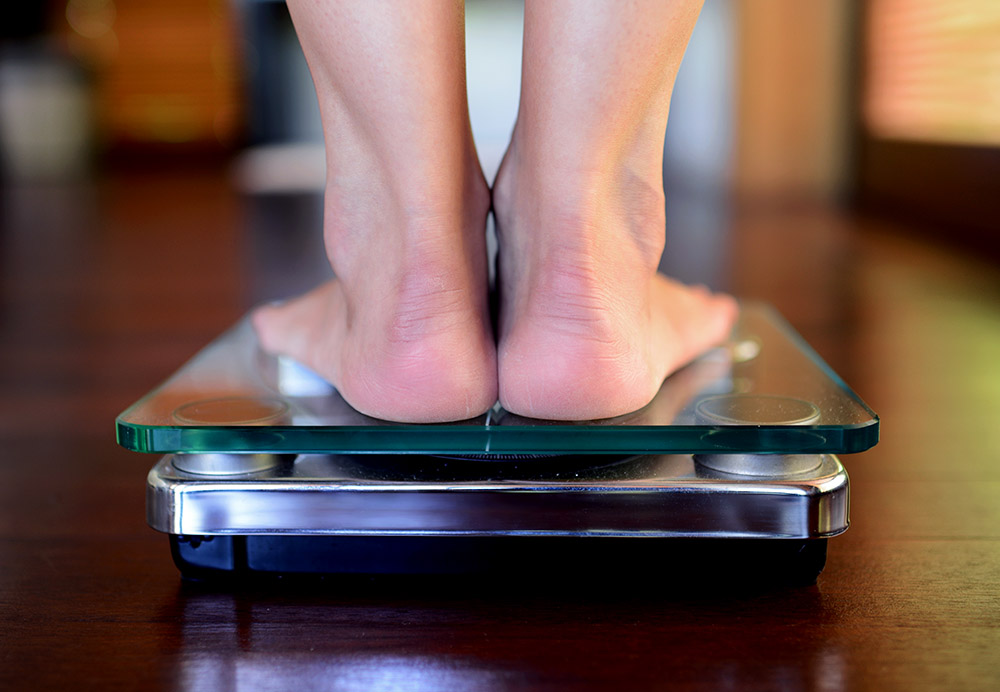 person standing on weighing scale