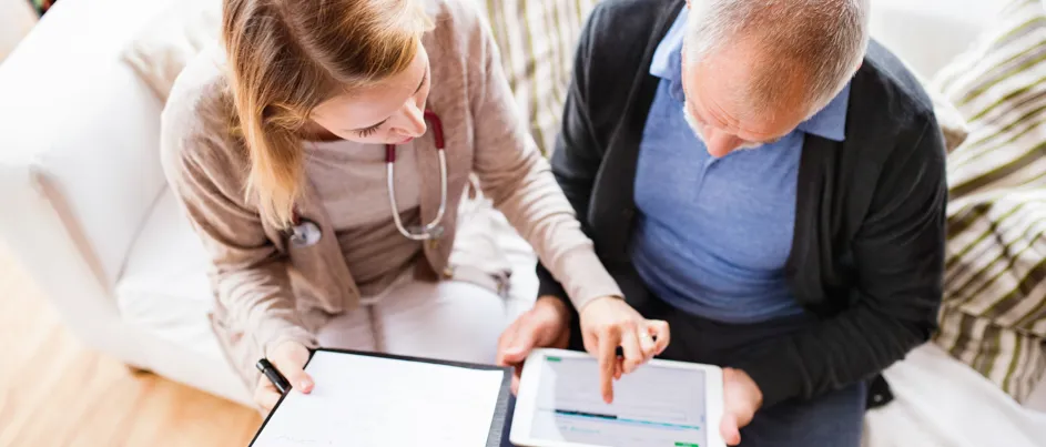 pancreatic cancer patient looking at clinical trial options with his doctor oncologist on an ipad