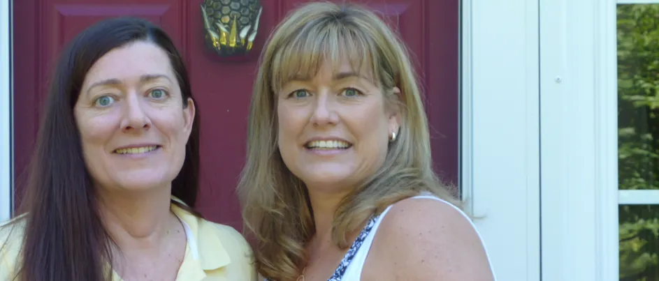 Kathy and Kelly standing next to one another smiling.