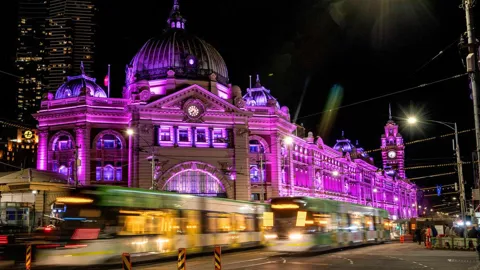 Flinders Street Station Melbourne lit up in purple