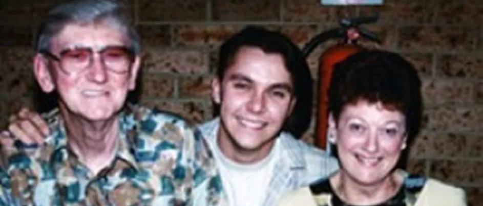 Kate with her husband and son smiling.