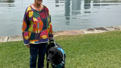 Leanne at the park with her guide dog 'Ester'