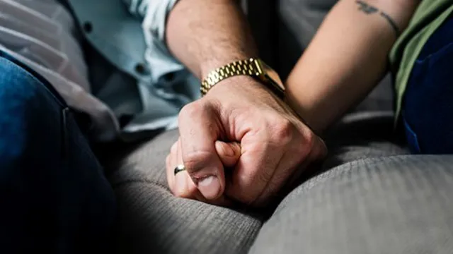 Two people holding hands