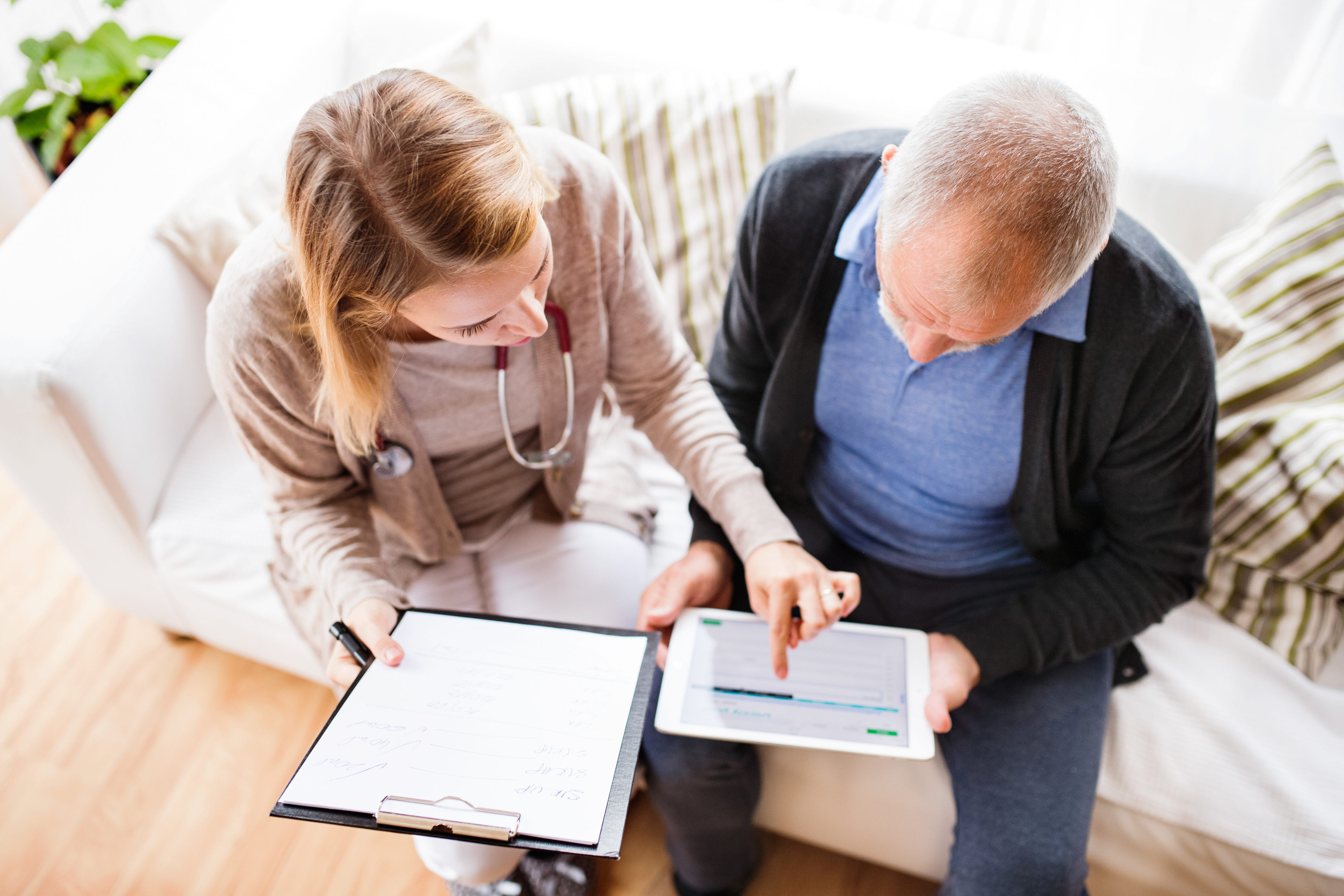 pancreatic cancer patient looking at clinical trial options with his doctor oncologist on an ipad