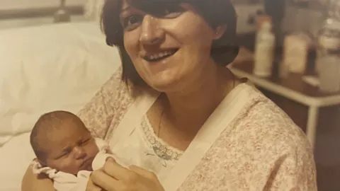Stephanie holding her baby daughter Sara.