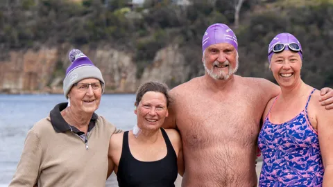 Chris, Ivan and friends all smiles after the milestone swim.