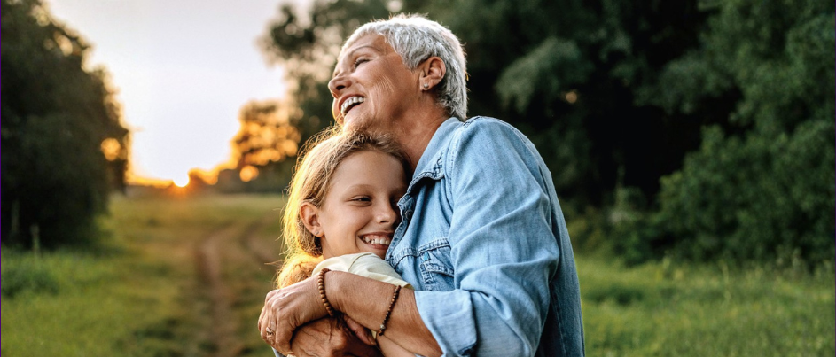 Grandparents hugging their grandchild