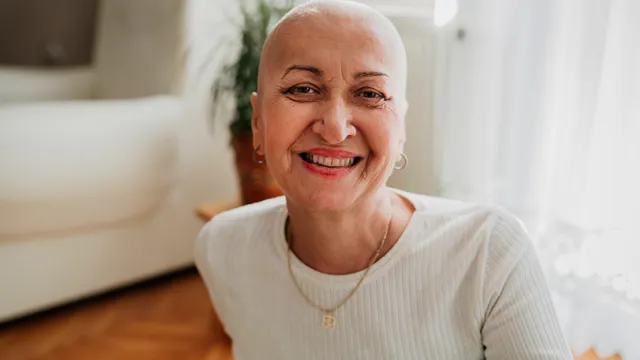A woman with cancer, smiling.